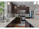 Kitchen with stainless steel appliances, granite countertops, mosaic backsplash, and ample counter space at 1319 Gable Lake Dr, Brownsburg, IN 46112