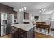 Open concept kitchen with stainless steel appliances, granite countertops, island, and ample dining space at 1319 Gable Lake Dr, Brownsburg, IN 46112