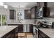 Modern kitchen with stainless steel appliances, granite countertops, and a mosaic tile backsplash at 1319 Gable Lake Dr, Brownsburg, IN 46112