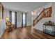 Inviting living room with hardwood floors, rocking chair, and open access to the foyer and stairway at 1319 Gable Lake Dr, Brownsburg, IN 46112