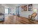 Bright living room with hardwood floors, rocking chair, and large windows offering plenty of light at 1319 Gable Lake Dr, Brownsburg, IN 46112
