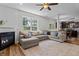 Open living space with fireplace and ample seating, with an view to an adjacent kitchen and dining area at 1319 Gable Lake Dr, Brownsburg, IN 46112