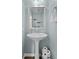 Clean powder room featuring pedestal sink, framed mirror, and fresh pale blue paint at 1319 Gable Lake Dr, Brownsburg, IN 46112