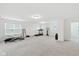 Spacious finished basement area with plush carpeting and workout equipment at 1338 Delacorte Cir, Shelbyville, IN 46176