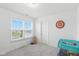 Bright bedroom with neutral walls and carpet, a window, and view of the neighborhood at 1338 Delacorte Cir, Shelbyville, IN 46176