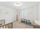 Bedroom with crib, changing table, and ample natural light at 1338 Delacorte Cir, Shelbyville, IN 46176
