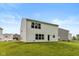Exterior shot of a home with white siding and a well-manicured lawn in the backyard at 1338 Delacorte Cir, Shelbyville, IN 46176