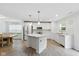 Modern kitchen with white cabinets, marble countertops, stainless steel appliances, and wood floors at 1338 Delacorte Cir, Shelbyville, IN 46176