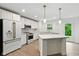 Beautiful kitchen with white cabinets, marble countertops, stainless steel appliances, and modern fixtures at 1338 Delacorte Cir, Shelbyville, IN 46176