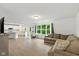 Open-concept living room with wood floors, a comfortable couch, and ample natural light at 1338 Delacorte Cir, Shelbyville, IN 46176