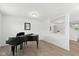Bright living room with wood floors, a black piano, natural light, and neutral-colored walls at 1338 Delacorte Cir, Shelbyville, IN 46176