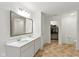 Bright main bathroom with double sink vanity, mirror, and closet at 1338 Delacorte Cir, Shelbyville, IN 46176