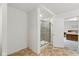 Modern bath area features glass shower, neutral paint, and tile flooring at 1338 Delacorte Cir, Shelbyville, IN 46176