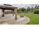 Cozy backyard featuring a gazebo with curtains and a stone fire pit at 14332 Eddington Pl, Fishers, IN 46037