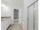 Bathroom with double vanity, tub, shower, and an open door to bedroom with ceiling fan at 14332 Eddington Pl, Fishers, IN 46037