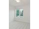 Well-lit bedroom with carpeted floors, ceiling fan, and a large window with lush green views at 14332 Eddington Pl, Fishers, IN 46037