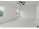 Bright bedroom featuring neutral carpet, a ceiling fan, and natural light from two windows at 14332 Eddington Pl, Fishers, IN 46037