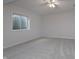 Bright bedroom with neutral carpet, window, and ceiling fan at 14332 Eddington Pl, Fishers, IN 46037