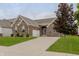 Charming single-story brick home with a well-manicured lawn and a paved driveway leading to an attached garage at 14332 Eddington Pl, Fishers, IN 46037