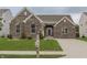 Beautiful brick home featuring a well-kept lawn, mature landscaping, and a classic mailbox near the driveway at 14332 Eddington Pl, Fishers, IN 46037