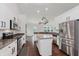 Spacious kitchen equipped with stainless steel appliances, granite countertops, a central island, and ample cabinet space at 14332 Eddington Pl, Fishers, IN 46037