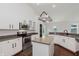 Bright kitchen featuring white cabinetry, stainless steel appliances, and a functional island, perfect for culinary endeavors at 14332 Eddington Pl, Fishers, IN 46037