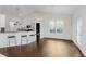 Bright kitchen with a breakfast bar, hardwood floors, and modern appliances, ideal for casual dining at 14332 Eddington Pl, Fishers, IN 46037