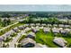 This aerial showcases a picturesque community with tree-lined streets and nearby ponds and greenways at 19009 Beverly Shones Ln, Noblesville, IN 46062