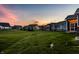 Spacious backyard of a new home development, featuring lush green lawns and inviting sunset views at 19009 Beverly Shones Ln, Noblesville, IN 46062