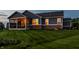 Well-manicured backyard featuring a screened in porch with exposed brick and string lights providing a cozy ambiance at 19009 Beverly Shones Ln, Noblesville, IN 46062