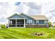 A manicured backyard and exterior elevation of the home featuring a screened in patio at 19009 Beverly Shones Ln, Noblesville, IN 46062