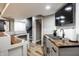 Basement bar with wooden countertops, stainless steel sink, tile backsplash and adjacent movie poster at 19009 Beverly Shones Ln, Noblesville, IN 46062