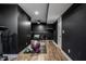 Finished basement boasts a home gym with modern flooring, black walls and exercise equipment at 19009 Beverly Shones Ln, Noblesville, IN 46062