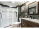 Modern bathroom with glass-enclosed shower, a new vanity, sink and a dark green accent wall at 19009 Beverly Shones Ln, Noblesville, IN 46062