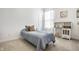 Cozy bedroom featuring a bed with a blue comforter, desk, and ample natural light at 19009 Beverly Shones Ln, Noblesville, IN 46062