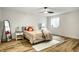 Modern bedroom with bed, white walls, vinyl floor, a mirror and a ceiling fan at 19009 Beverly Shones Ln, Noblesville, IN 46062