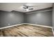 A minimalist, empty room with vinyl plank flooring and a ceiling fan at 19009 Beverly Shones Ln, Noblesville, IN 46062