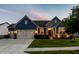 Charming home showcasing blue siding, brick accents, manicured lawn, and inviting two-car garage at 19009 Beverly Shones Ln, Noblesville, IN 46062