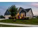 Charming home with a well-maintained lawn, showcasing its inviting facade and landscaping at sunset at 19009 Beverly Shones Ln, Noblesville, IN 46062