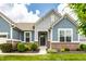 Inviting entryway showcasing brick accents, manicured lawn, and an attractive front door at 19009 Beverly Shones Ln, Noblesville, IN 46062