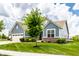 Charming two-story home with blue siding, brick accents and a well-manicured lawn and landscaping at 19009 Beverly Shones Ln, Noblesville, IN 46062