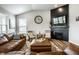 Cozy living room features vaulted ceilings, modern ceiling fan, and a stylish fireplace at 19009 Beverly Shones Ln, Noblesville, IN 46062