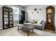 Cozy living room with a gray sofa, bookshelves, and a grandfather clock at 19009 Beverly Shones Ln, Noblesville, IN 46062