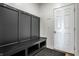 Well-organized mudroom with a black bench and coat rack, perfect for storage and entryway at 19009 Beverly Shones Ln, Noblesville, IN 46062