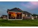 Inviting screened-in patio with string lights, offering a cozy outdoor living space with views of the landscaped backyard at 19009 Beverly Shones Ln, Noblesville, IN 46062