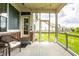 The screened-in porch features views of the manicured backyard, ceiling fan and string lights at 19009 Beverly Shones Ln, Noblesville, IN 46062
