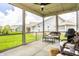 The screened-in porch features a ceiling fan and string lights for relaxing evenings at 19009 Beverly Shones Ln, Noblesville, IN 46062