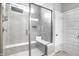 Modern shower featuring gray tile, a built-in bench, and a glass door at 19009 Beverly Shones Ln, Noblesville, IN 46062