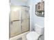 Bathroom featuring a shower with glass doors, white toilet, and rustic-style wooden cabinet with decorative plant at 20845 Summit Rd, Noblesville, IN 46062