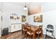 Charming dining area features wood flooring, a rustic wood table, and decorative wall art at 20845 Summit Rd, Noblesville, IN 46062